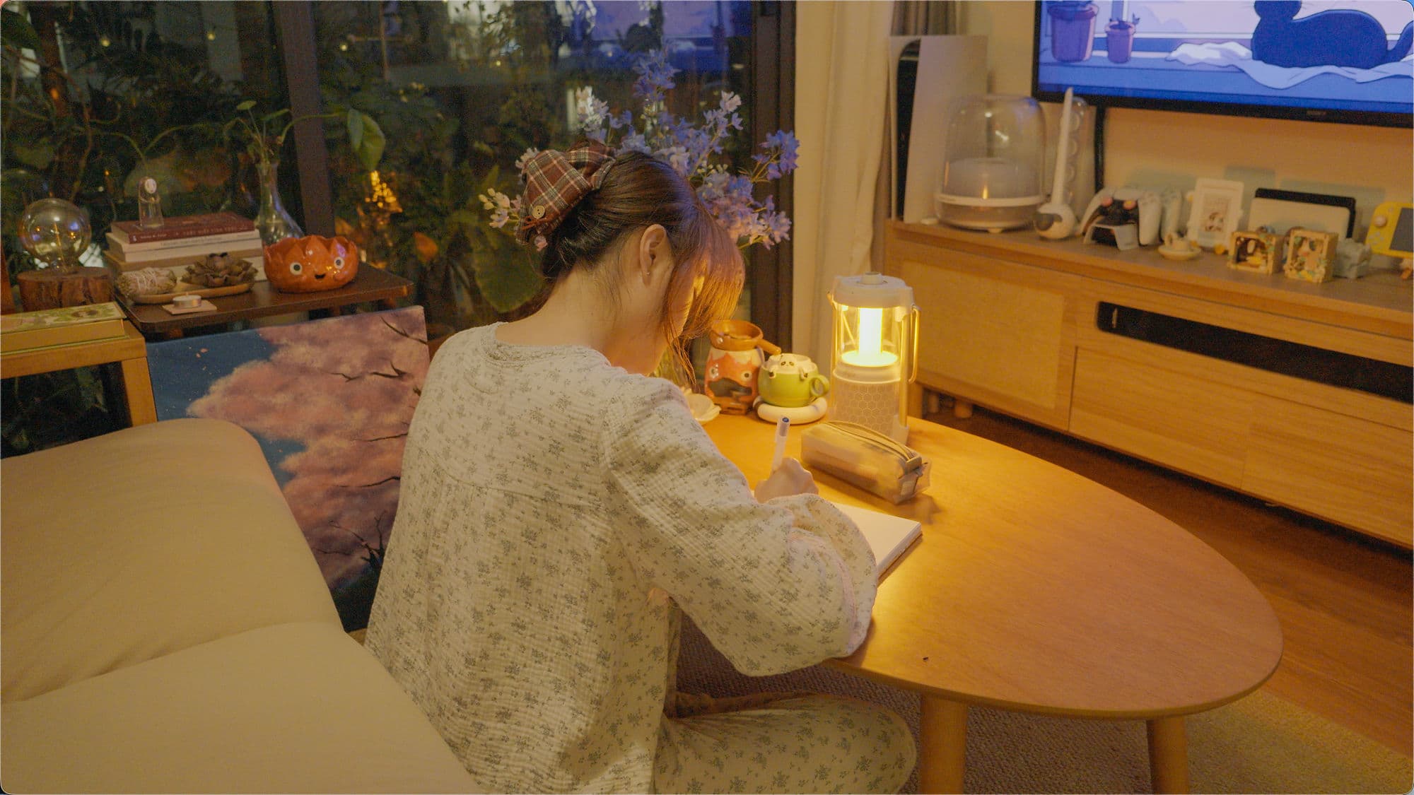 Cece journaling by lamplight